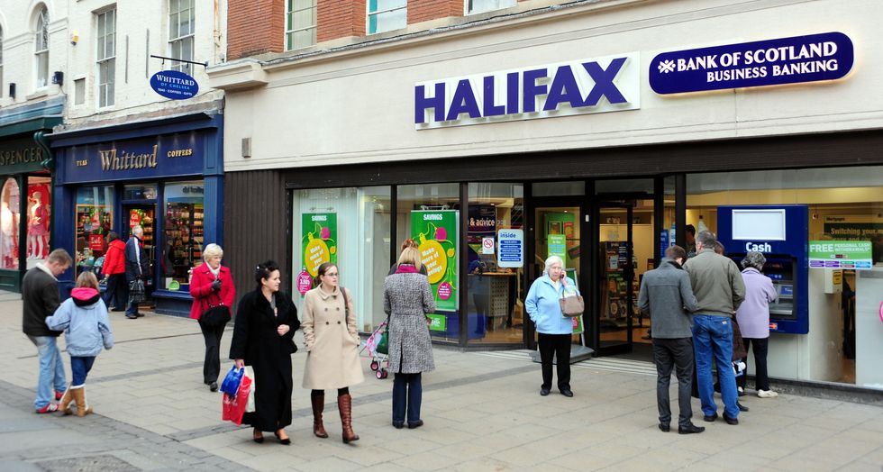 Christmas shoppers walk past a Whittard of Chelsea's and a branch of Halifax York city centre