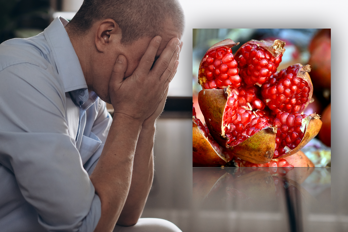 Composite image of man holding head in hands and  pomegranate fruit 