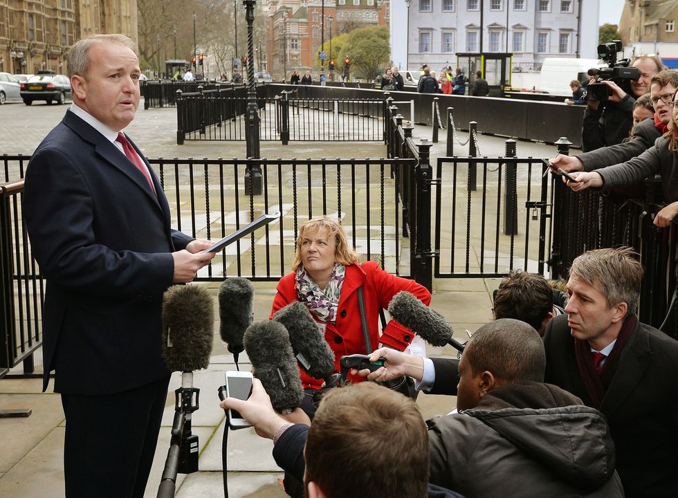 Conservative MP Mark Pritchard reads a statement outside St Stephen's entrance at the Houses of Parliament in London