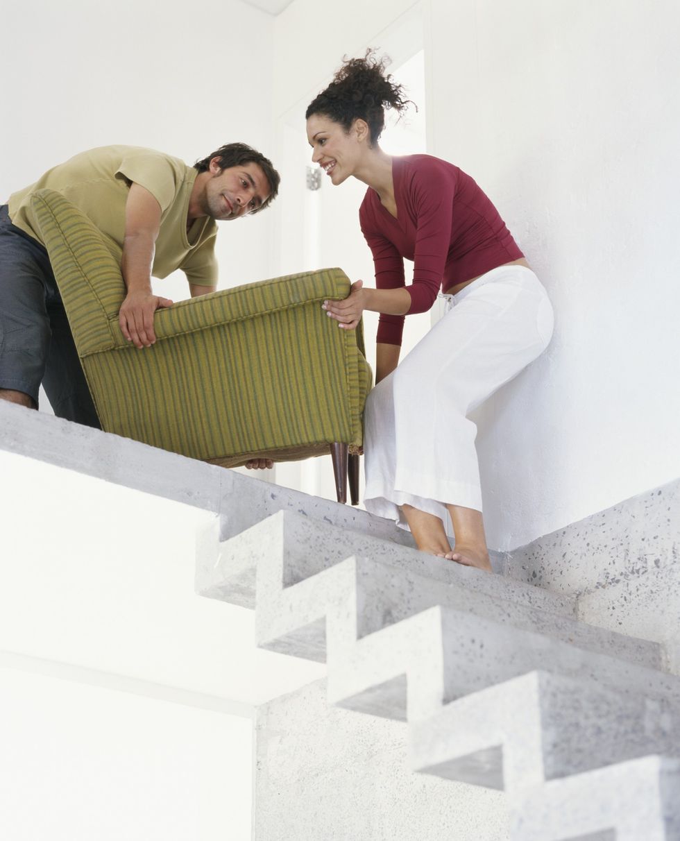 Couple moving a chair