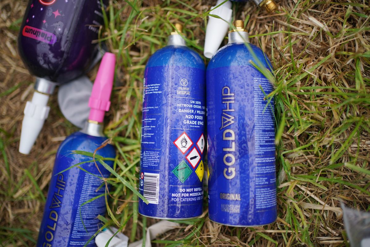 Discarded nitrous oxide canisters in a car park, at the Glastonbury Festival at Worthy Farm in Somerset
