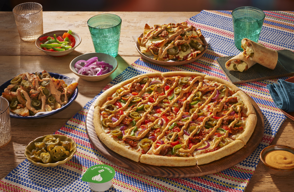 Domino's Mexican menu pizza and nachos on a table