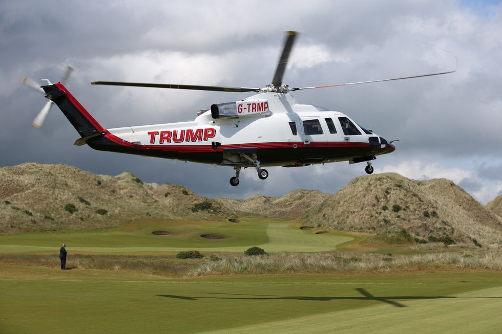 Donald Trump arrives by helicopter at the Trump International Golf Links at Balmedie