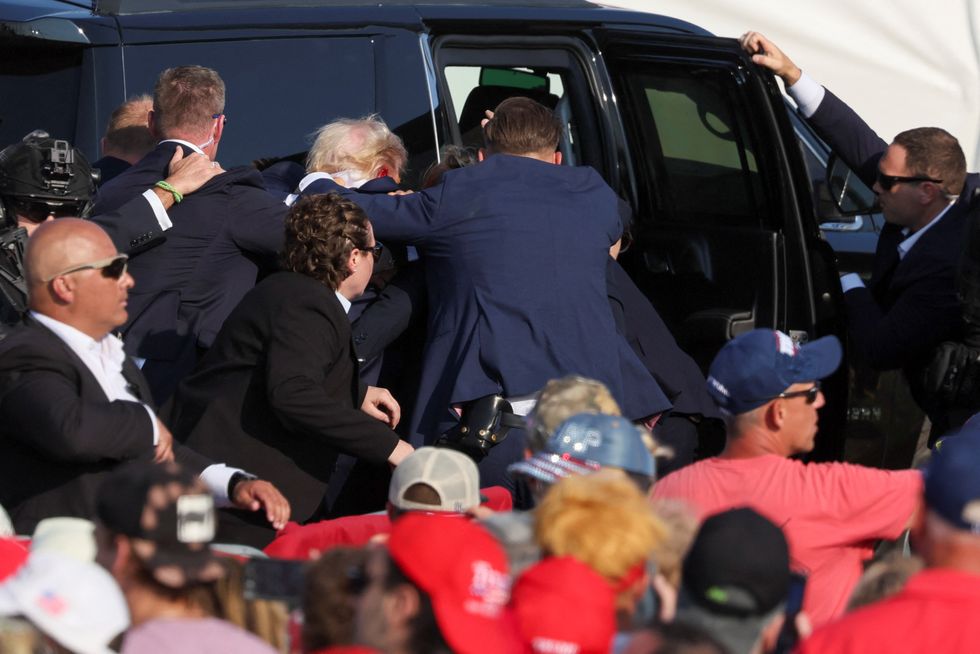 Donald Trump bundled into car