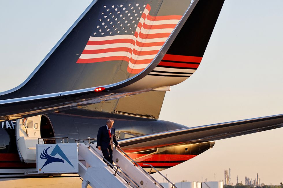 Donald Trump walking down the steps of his Trump-branded planeu200b