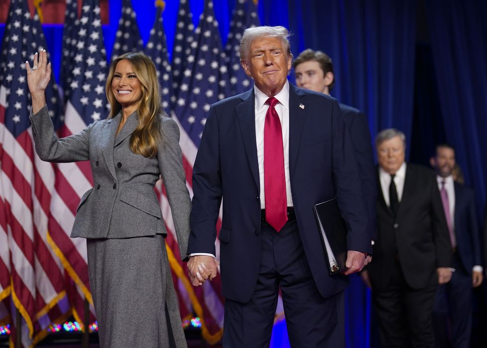 Donald Trump walks out on stage with his wife Melania after being declared the winner during an election night watch party at the Palm Beach County Convention Center