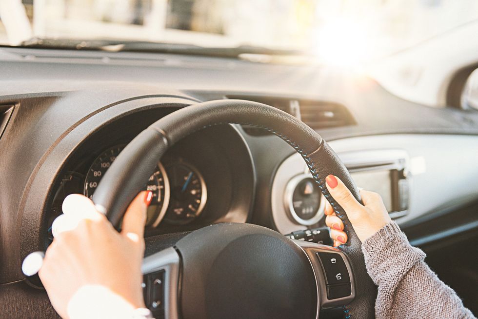 Driver in car behind wheel