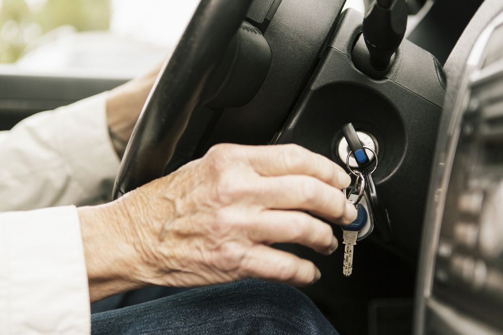 elderly driver in car