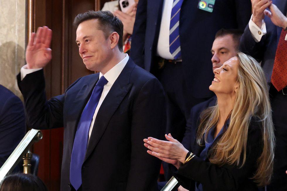 Elon Musk salutes as he's hailed by Trump during the speech