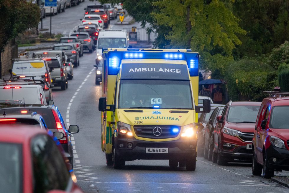 Emergency service ambulance driving through Bath