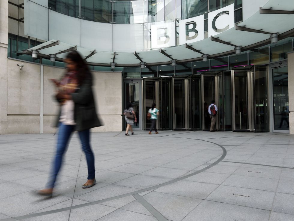 Employees arrive at Broadcasting House, London