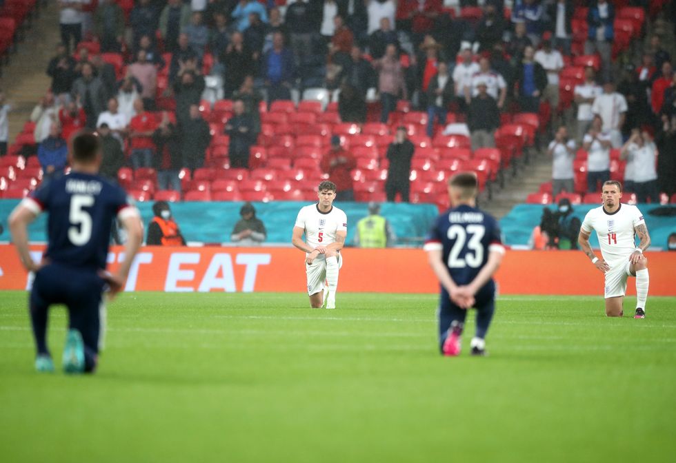 England's John Stones (second left) and Kalvin Phillips (right) take a knee prior to the UEFA Euro 2020 Group D match at Wembley Stadium, London. Picture date: Friday June 18, 2021.