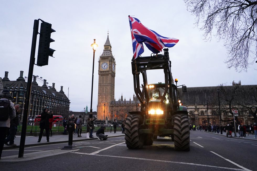 Farmers take part in a tractor "go-slow" through Parliament Square, Westminster,