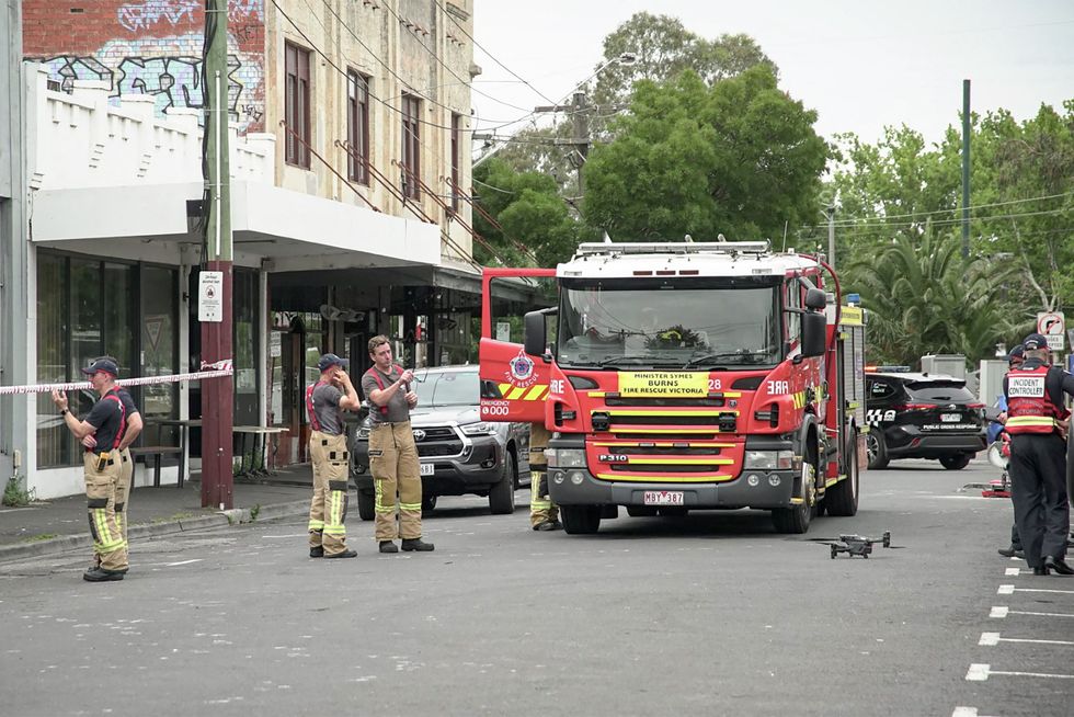 Fire fighters gather at the scene of a fire at the Adass Israel Synagogue in Melbourne