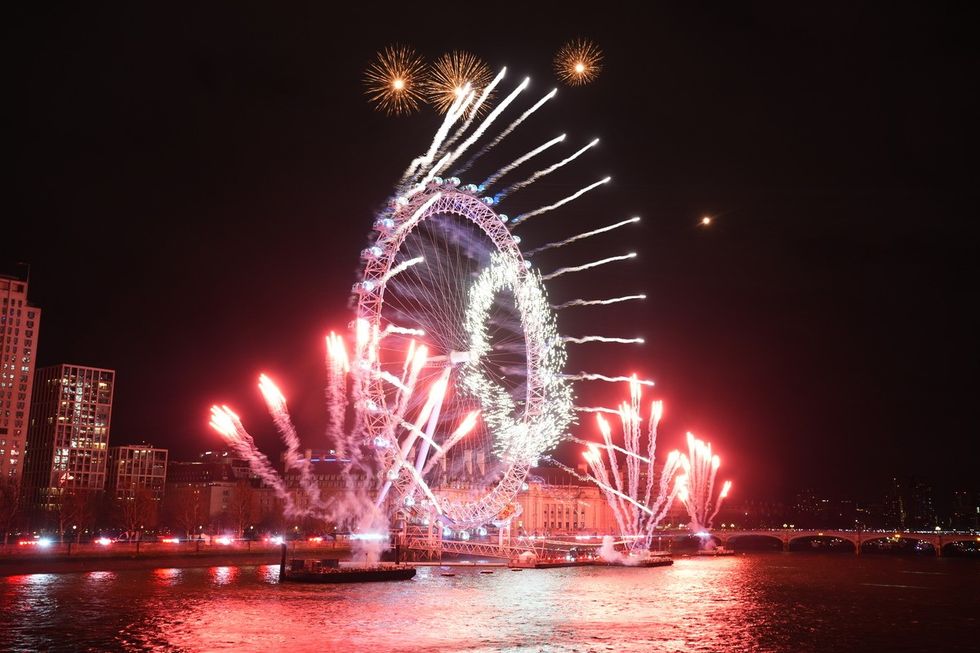 Fireworks light up the sky over the London Eye in central London during the New Year celebrations.