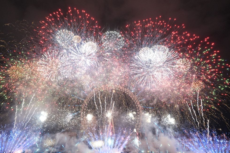 Fireworks light up the sky over the London Eye in central London during the New Year celebrations