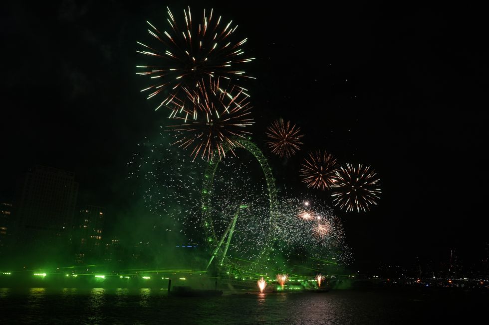 Fireworks light up the sky over the London Eye in central London during the New Year celebrations