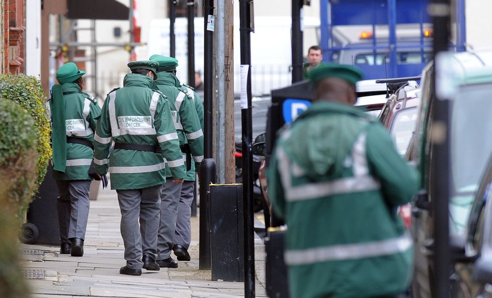 Five Civil Enforcement Officers patrol a street in Clapham, London.