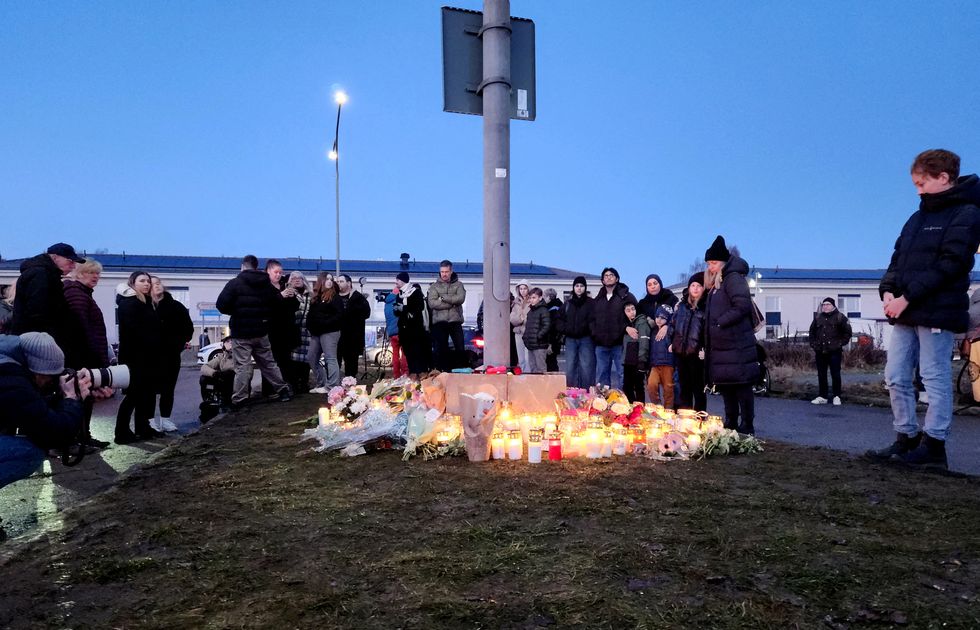 Flowers and candles are placed near the Campus Risbergska school