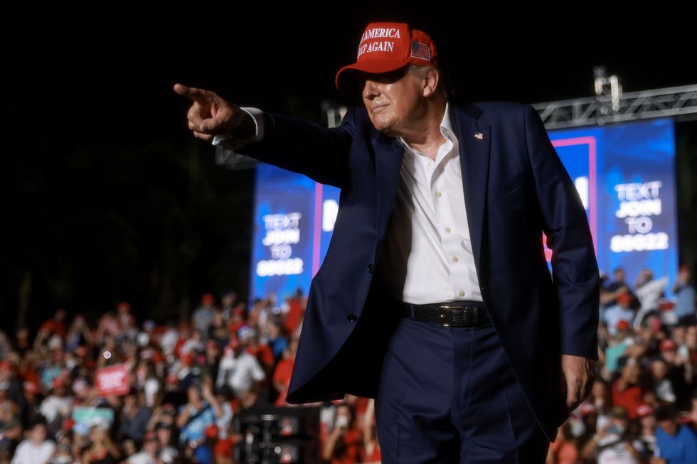 Former U.S. President Donald Trump leaves after speaking at a campaign rally at the Trump National Doral Golf Club