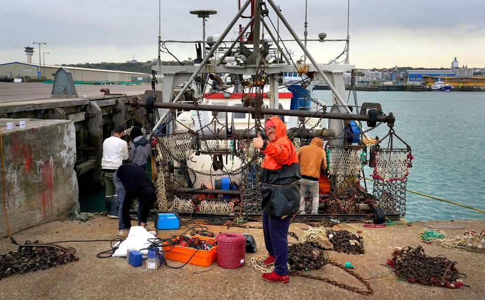 French fisherman Pierre Hagnerz prepares his boat for sea at the port of Boulogne, France