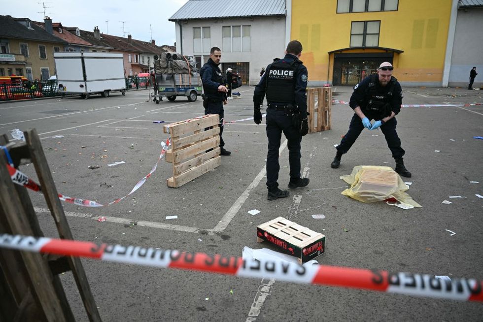 French municipal police officers work to collect evidence at the site of a bladed weapon attack