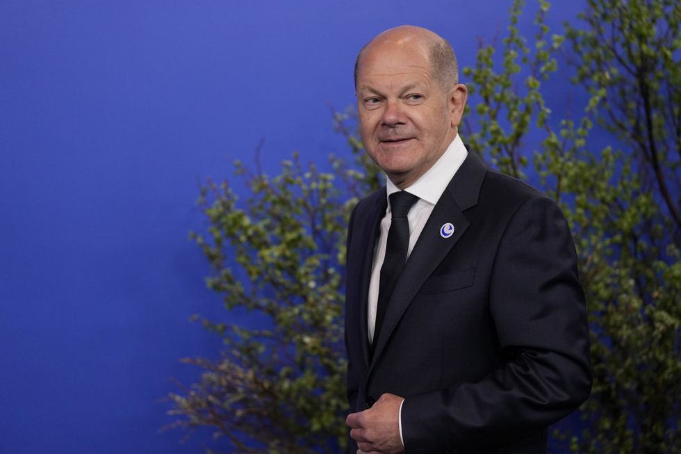 Germany's Chancellor Olaf Scholz (right) arrives at the the Harpa concert hall where a Council of Europe summit will take place in Reykjavik, Iceland