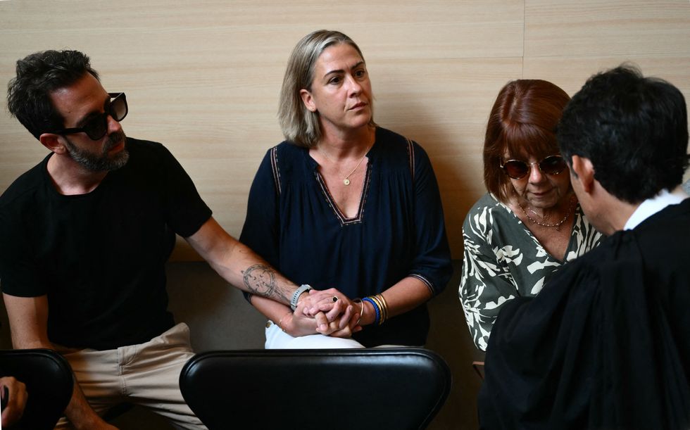 Gisele Pelicot (R) speaks to one of her lawyers, beside her daughter Caroline Darian (C) and her son Florian Pelicot (L),