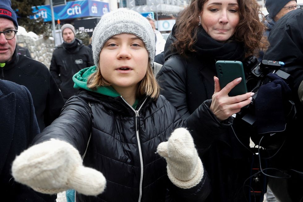 Greta Thunberg gestures as she walks outside during the World Economic Forum in Davos.