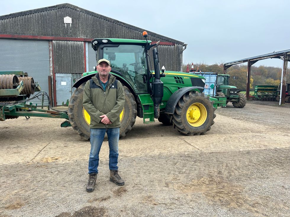 Guy Tucker standing in front of his tractor