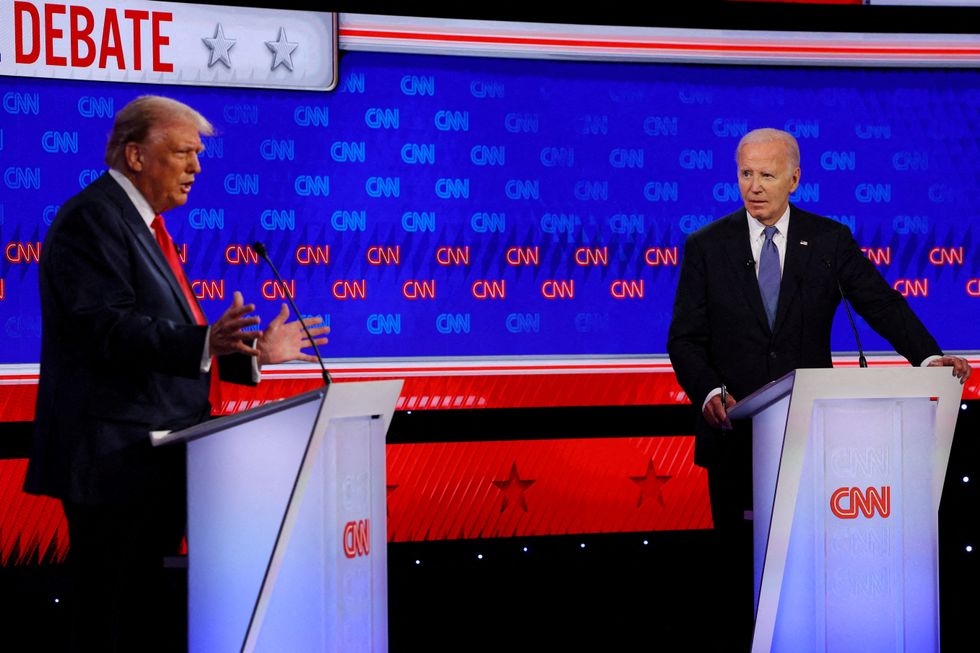 Joe Biden listens as Republican presidential candidate and former U.S. President Donald Trump speaks during their debate in Atlanta