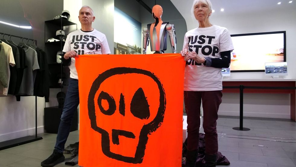 Just Stop Oil protesters in a Tesla shop in London