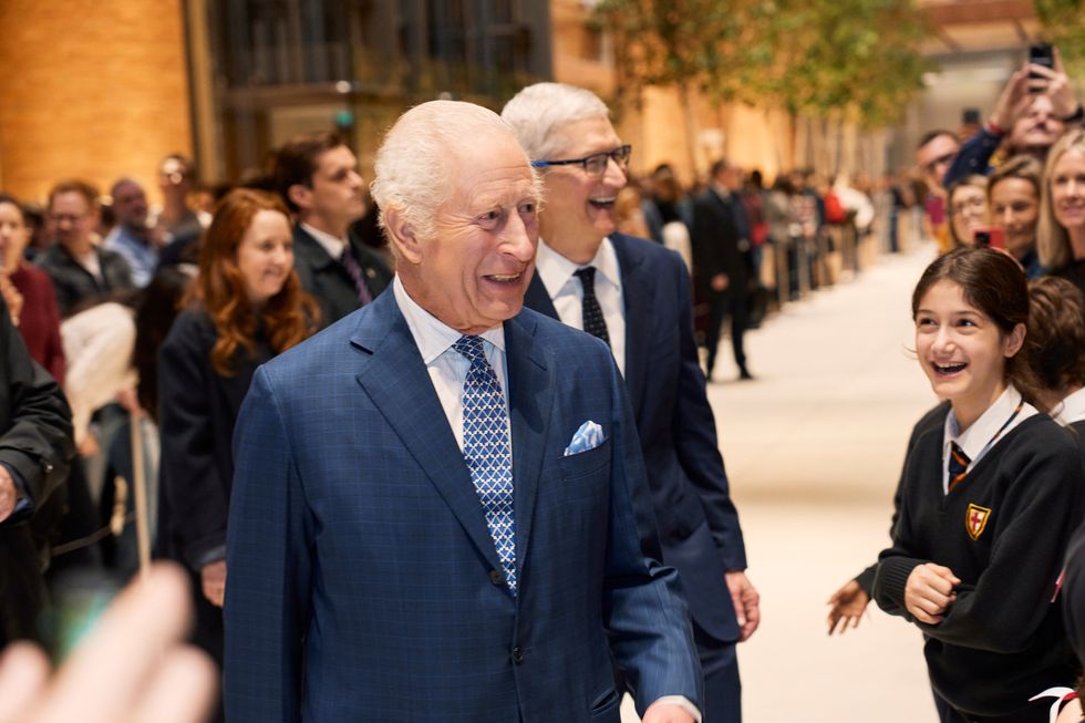 King Charles III and Apple CEO Tim Cook pictured laughing with children from the local St. Georgeu2019s Primary School