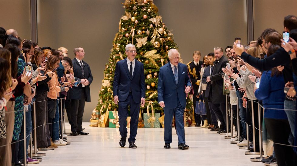 King Charles III and Apple CEO Tim Cook pictured walking through the battersea headquarters