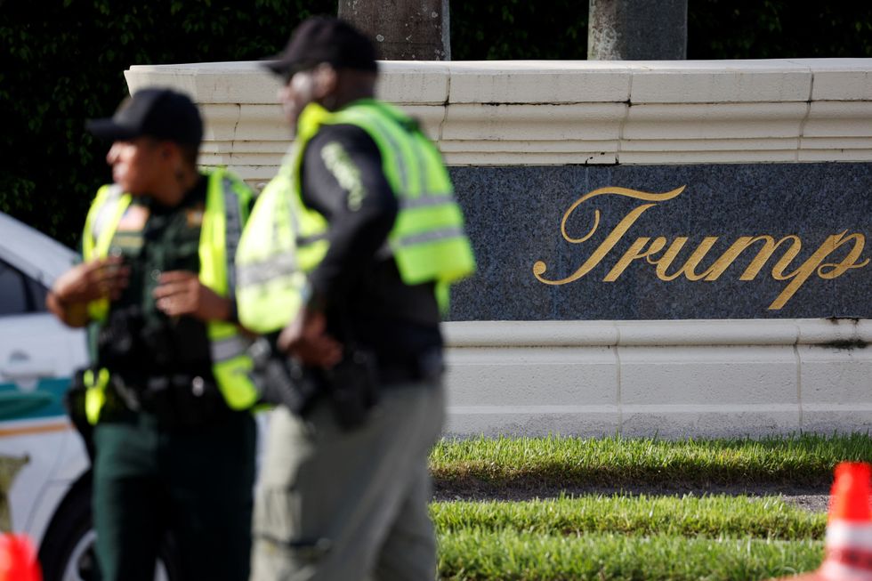 Law enforcement officers stand after reports of shots fired outside Republican presidential nominee and former U.S. President Donald Trump's Trump International Golf Course