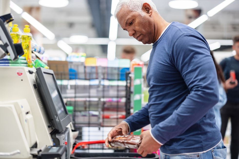 Man at self-checkout till