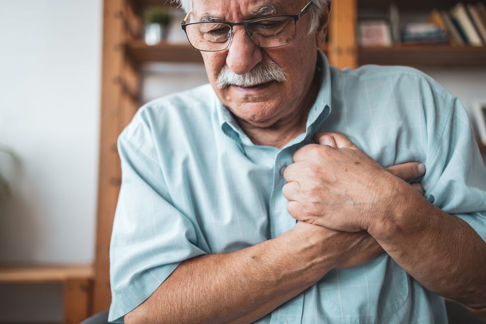 Man gripping his chest