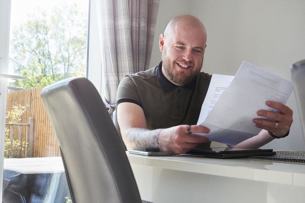 Man happy looking at bills