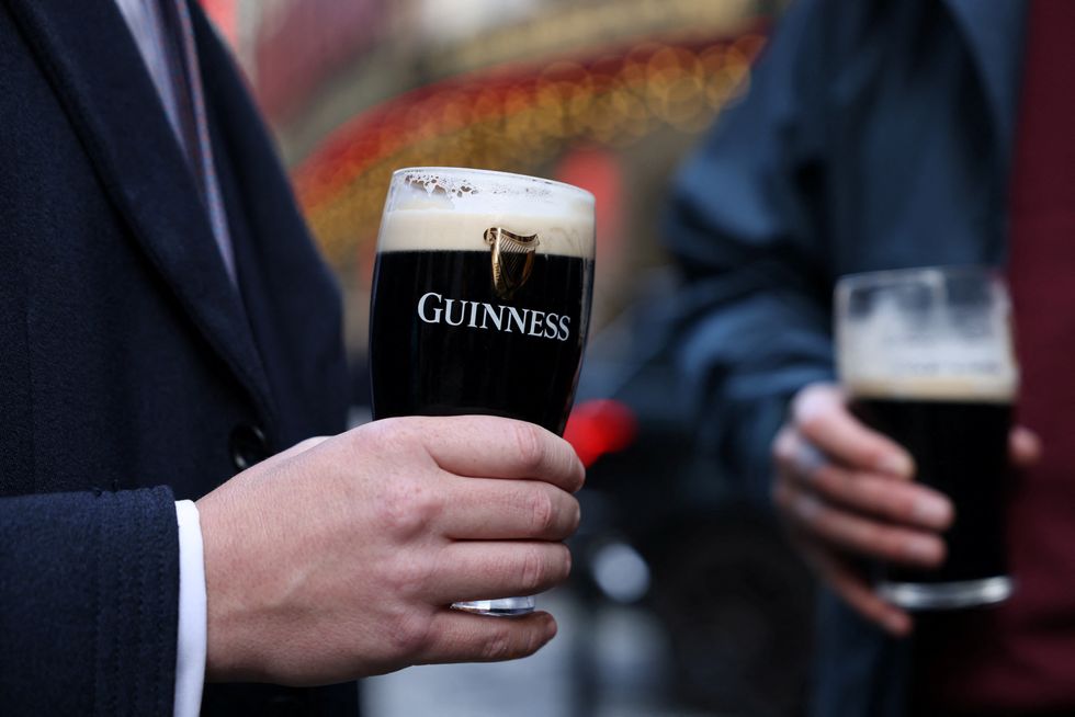 Man holding pint of Guinness