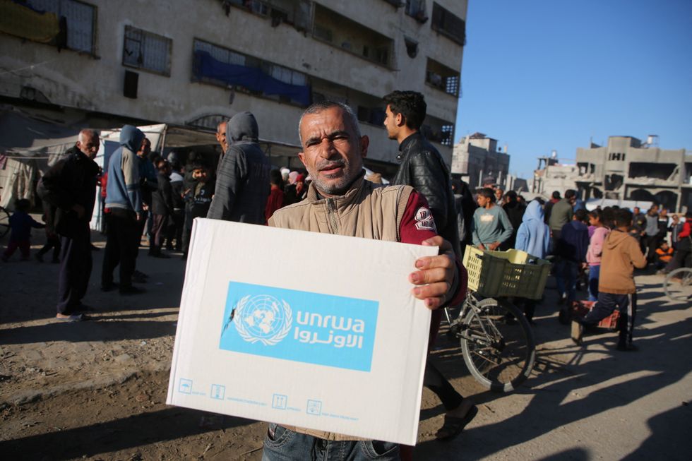 Man holding Unrwa aid