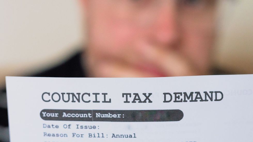 Man looking at council tax bill 