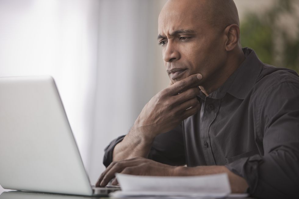 Man looks worried at his laptop