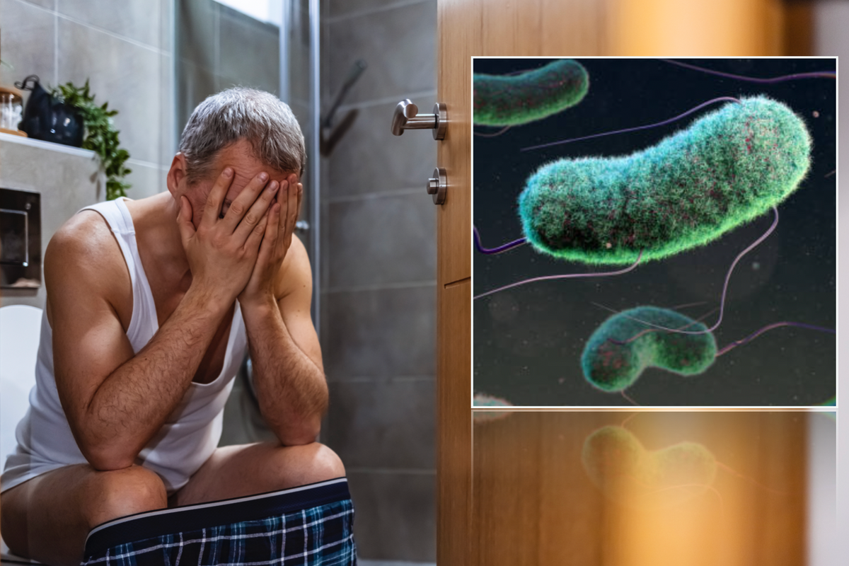 Man on toilet next to E.coli particle 