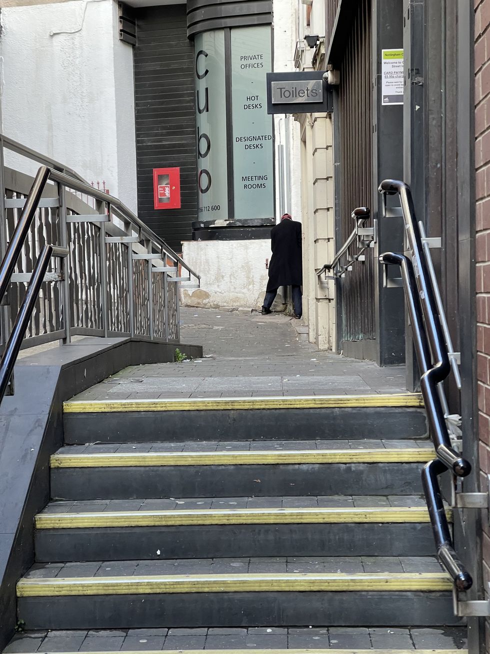 Man publicly urinating just metres away from the bathroom