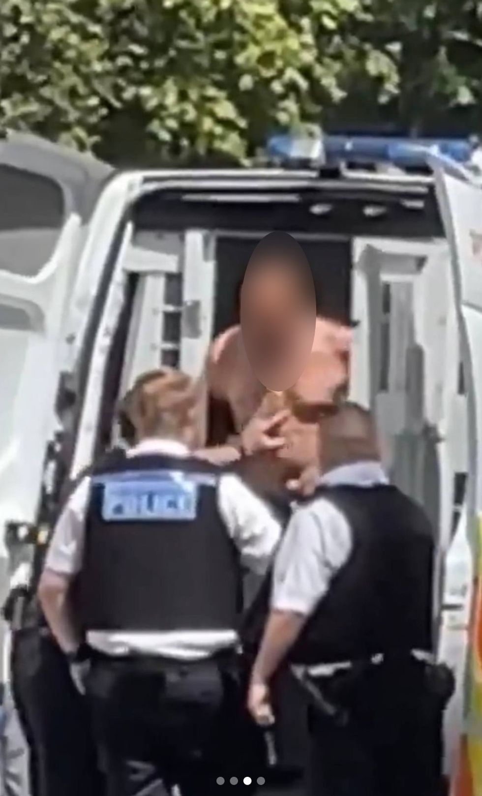 Man put in back of police van