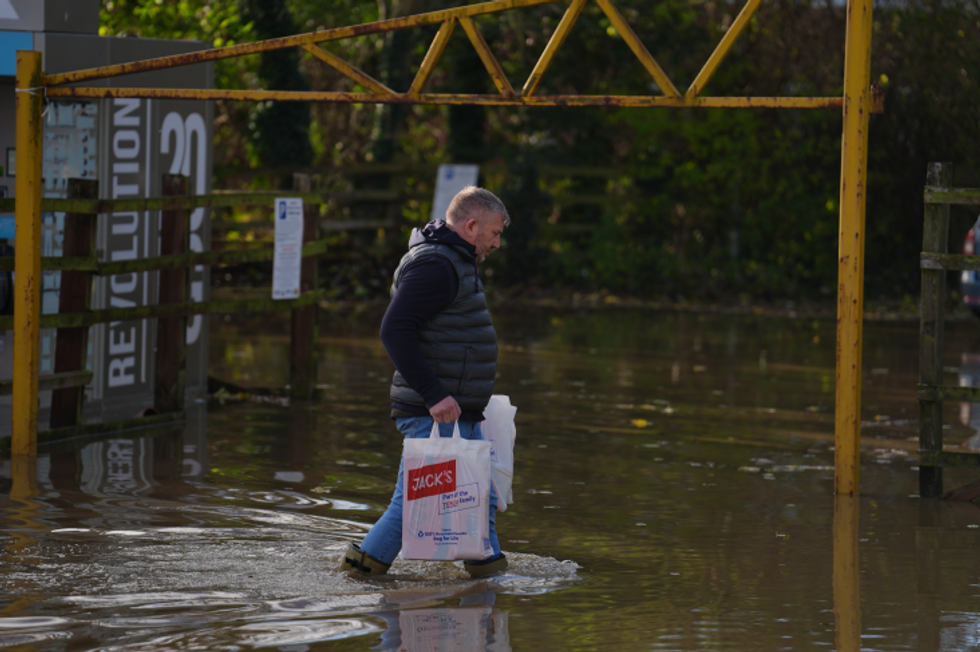 Man walking through flooded streets