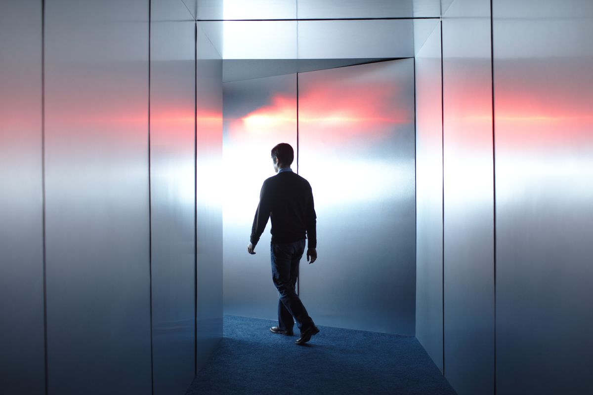 Man walking towards beam of light