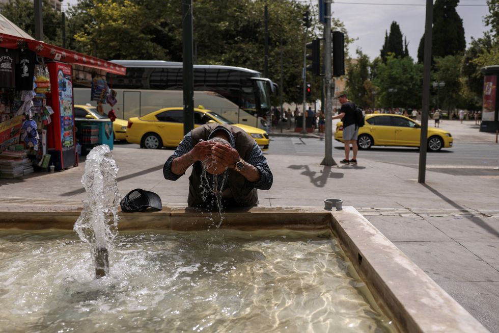 Man washes head in fountain