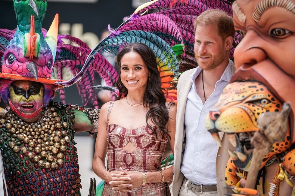 Meghan Markle and Prince Harry were greeted by carnival dancers