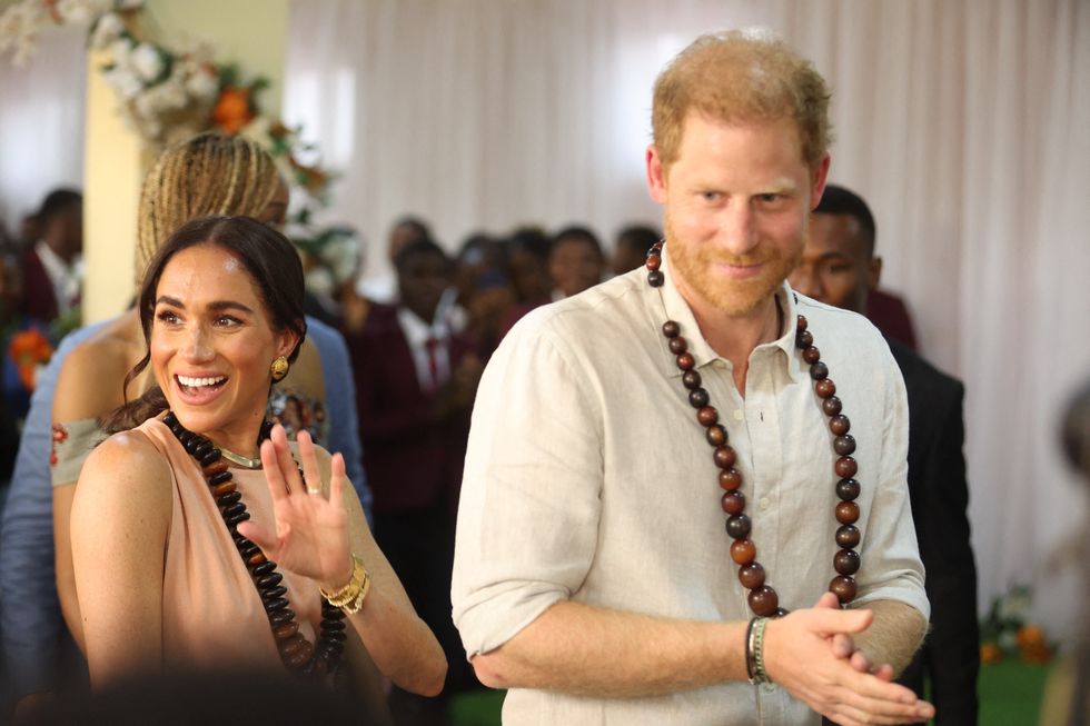 Meghan Markle beams alongside Prince Harry as she waves to crowd during ...